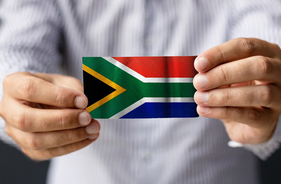 Hands holding the South African flag